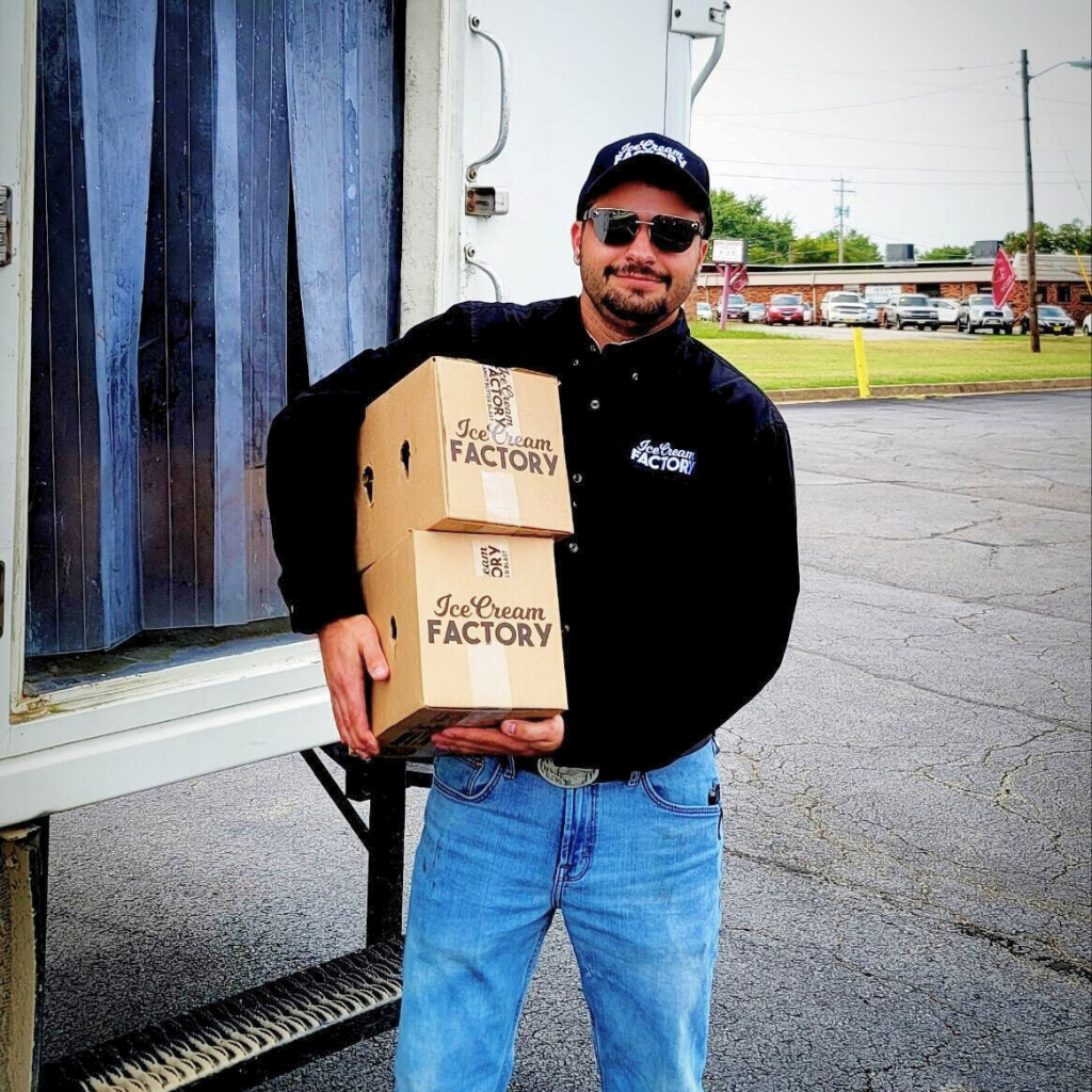 Ice Cream Delivery guy holding 2 boxes of pints